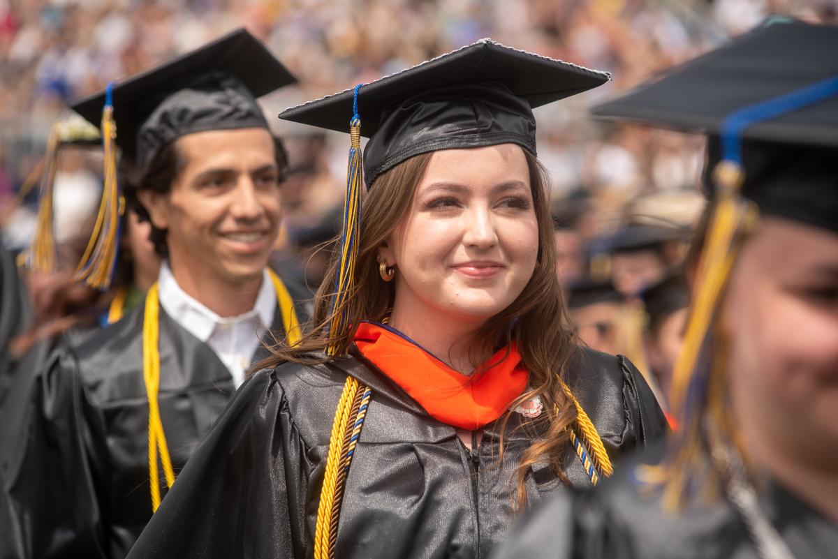A student walking at graduation