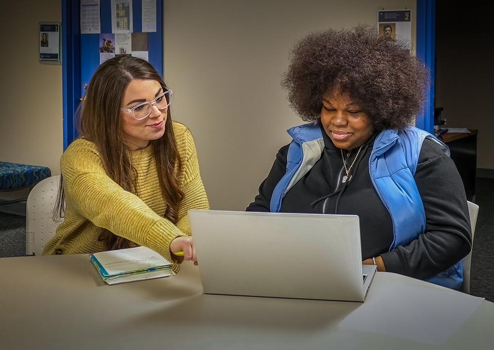 A student working with a faculty member